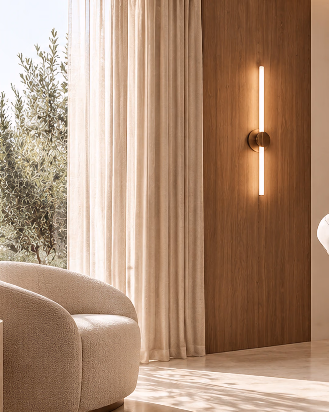 Armchair, linen curtains and a walnut wall with a slim wall light